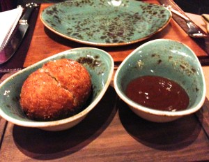 Scotch egg on a trencher - sans serving spoons. 