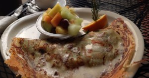 Spinach Mushroom Crepe with a side of fruit. 